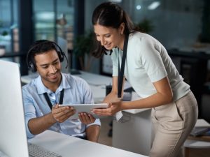 Picture of call centre staff showing supervisor his screen