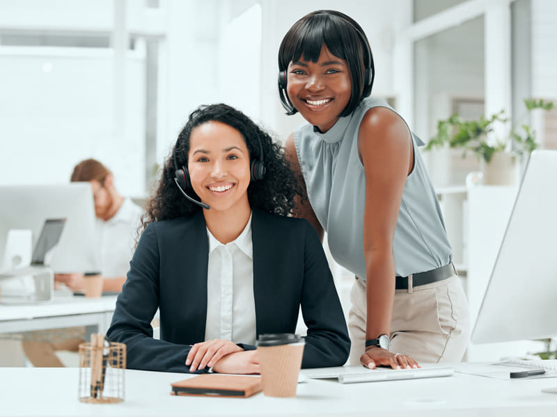 Picture of two call centre staff smiling