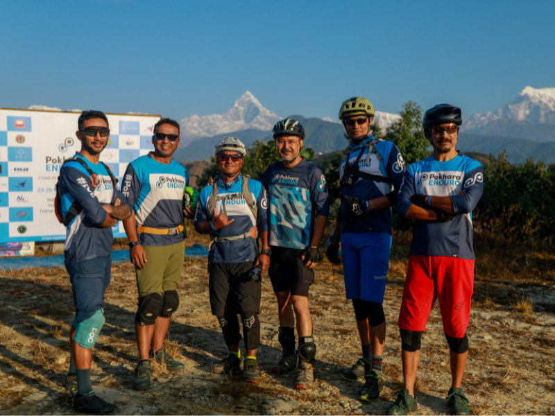 Pokhara Enduro Race, group photo with mountains in background.