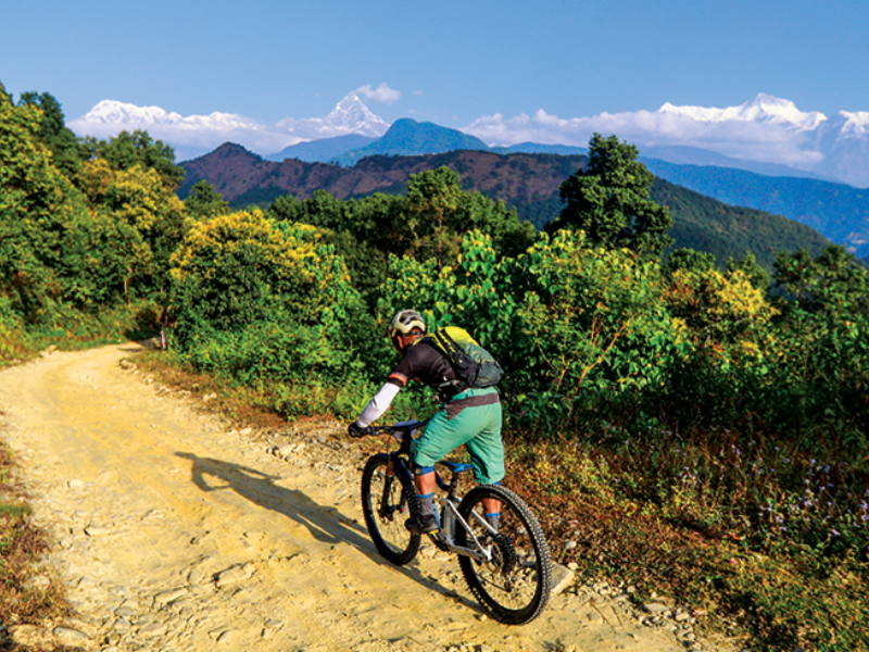 Pokhara Enduro Race Biker with Himalayas in background.
